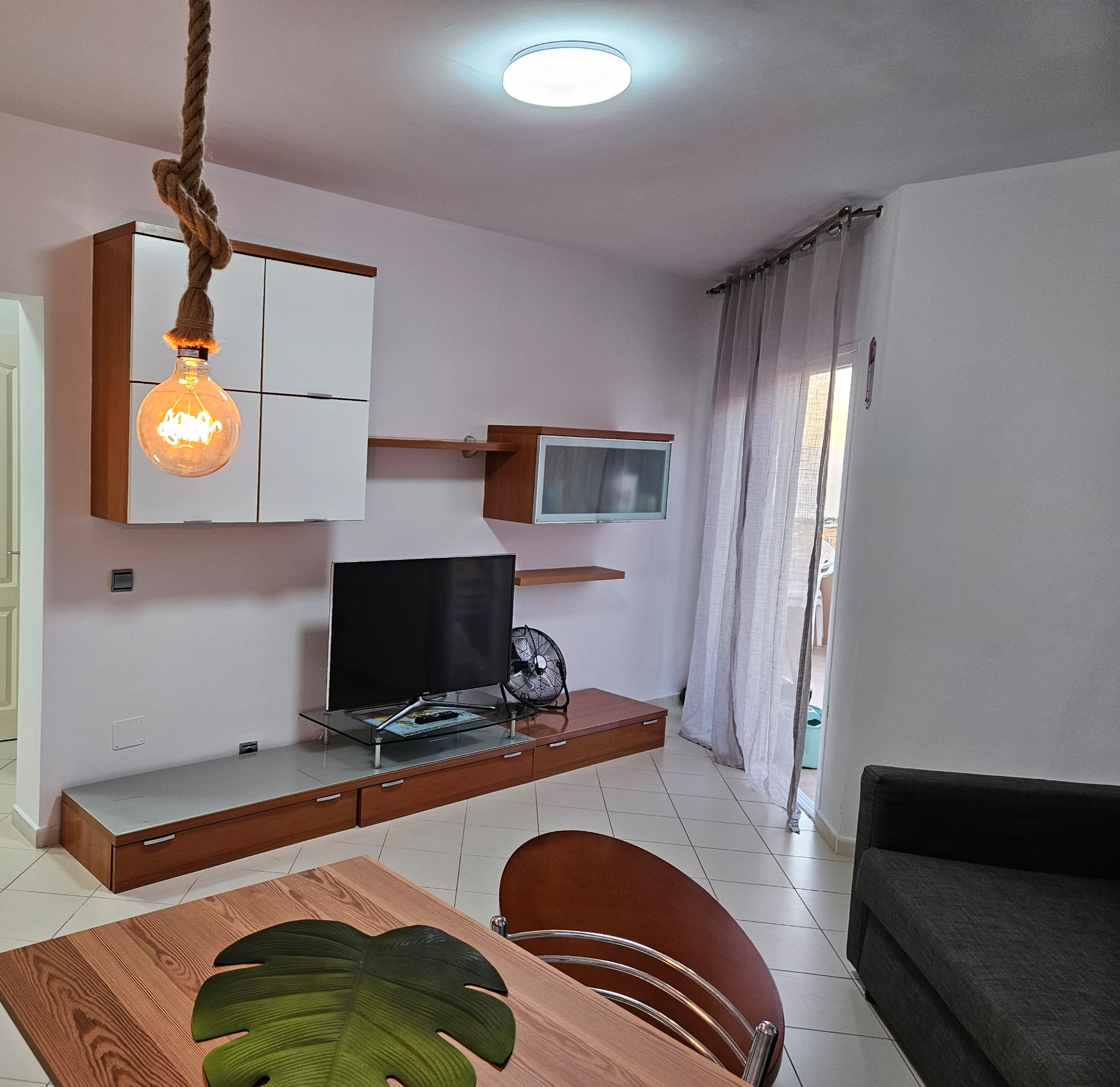 Living room with TV and terrace door