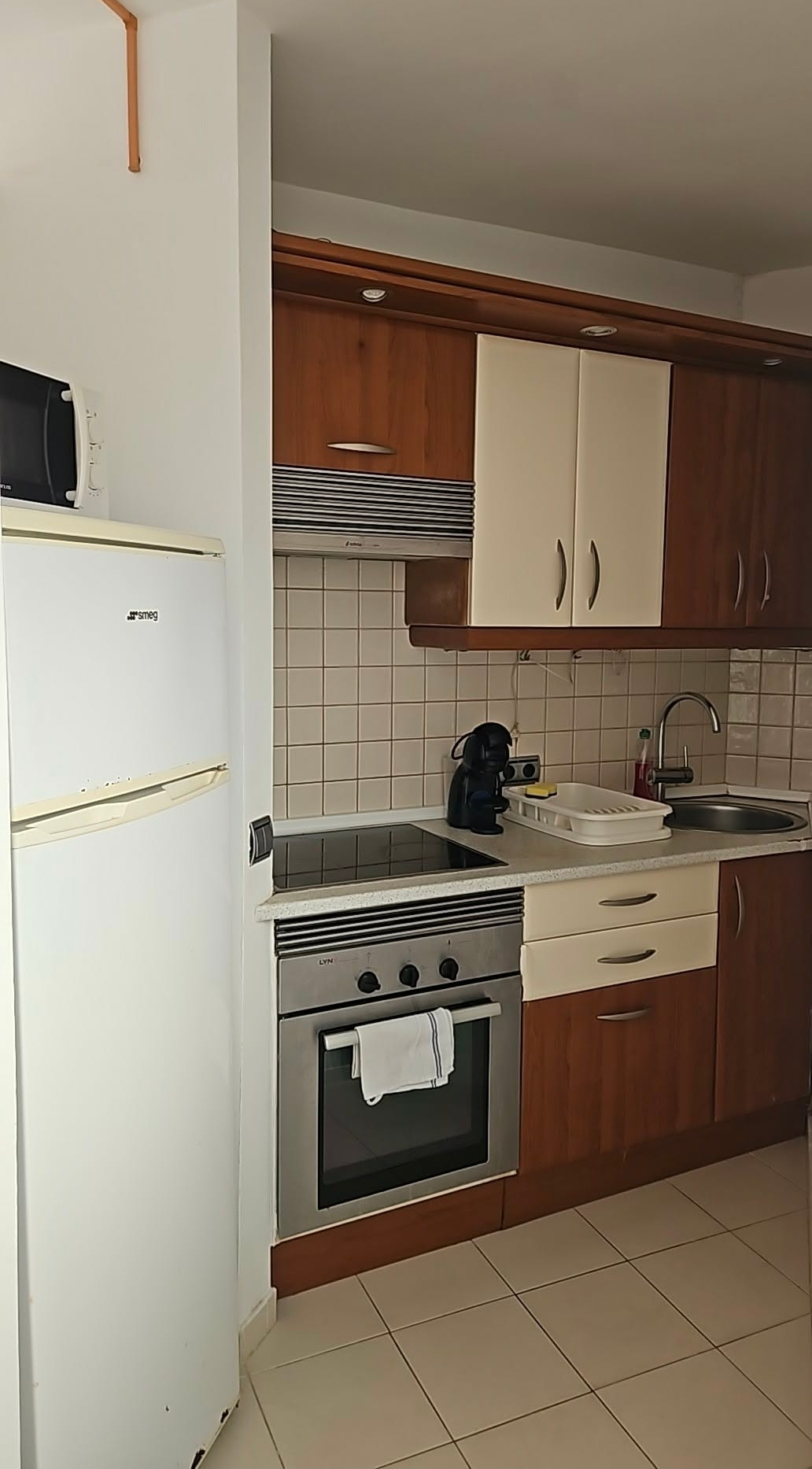 Kitchen with fridge, oven and microwave