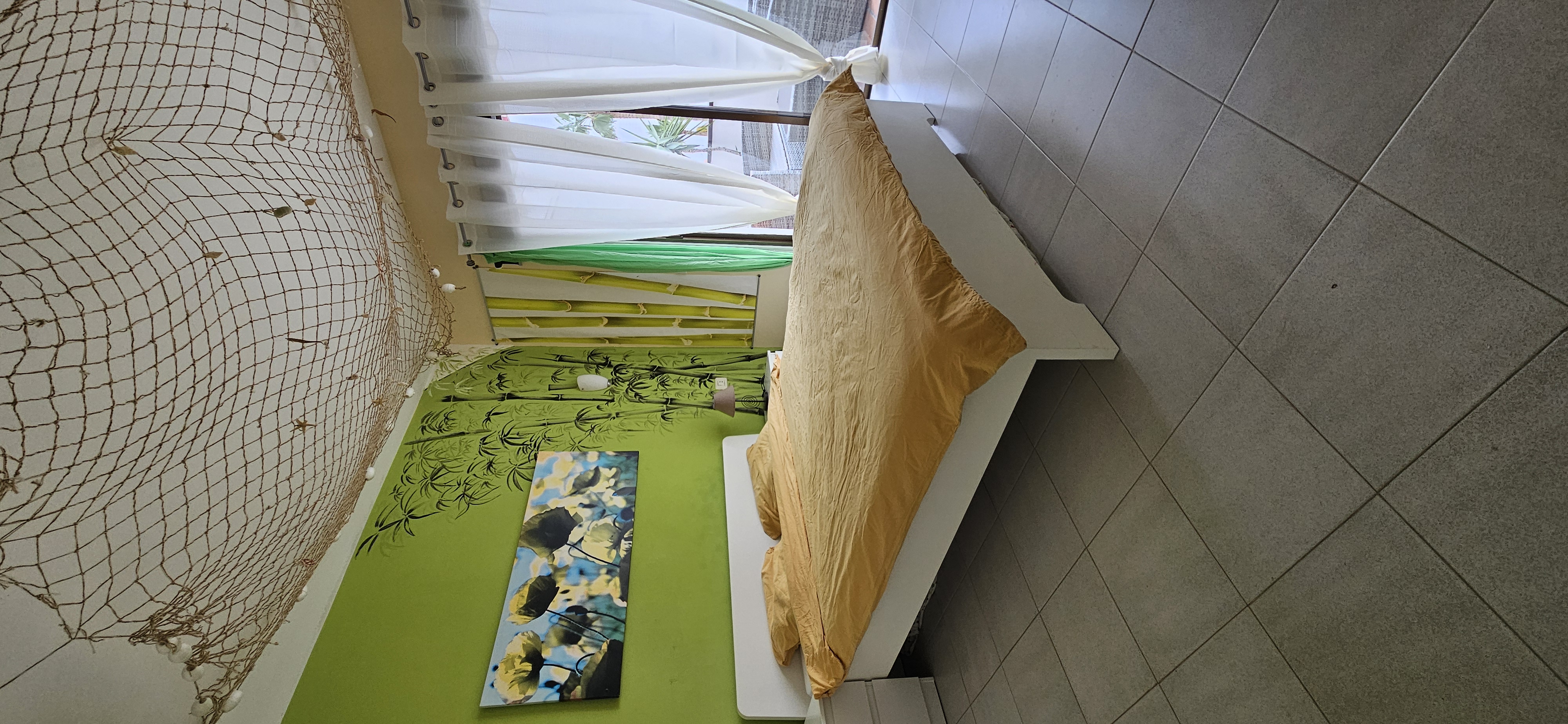 Bedroom with double bed and green wall