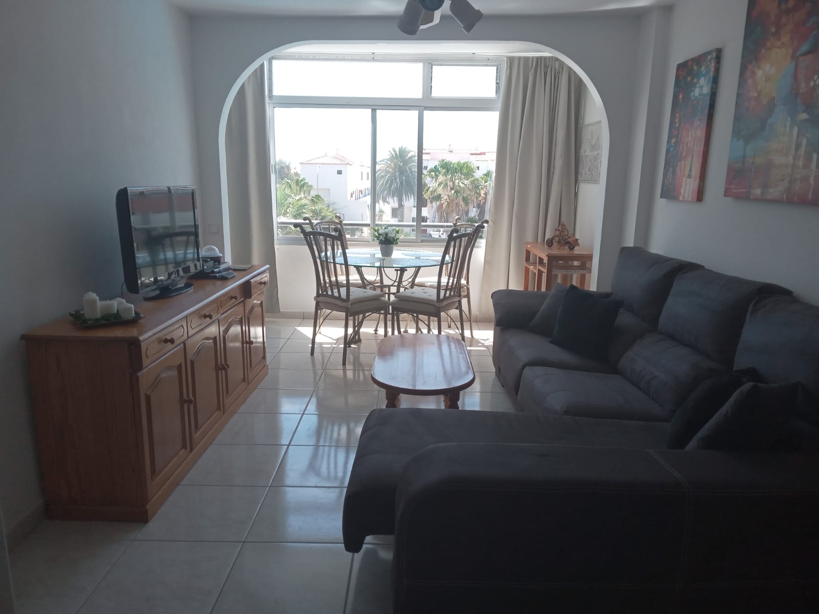 Living room with sofa, table and balcony door