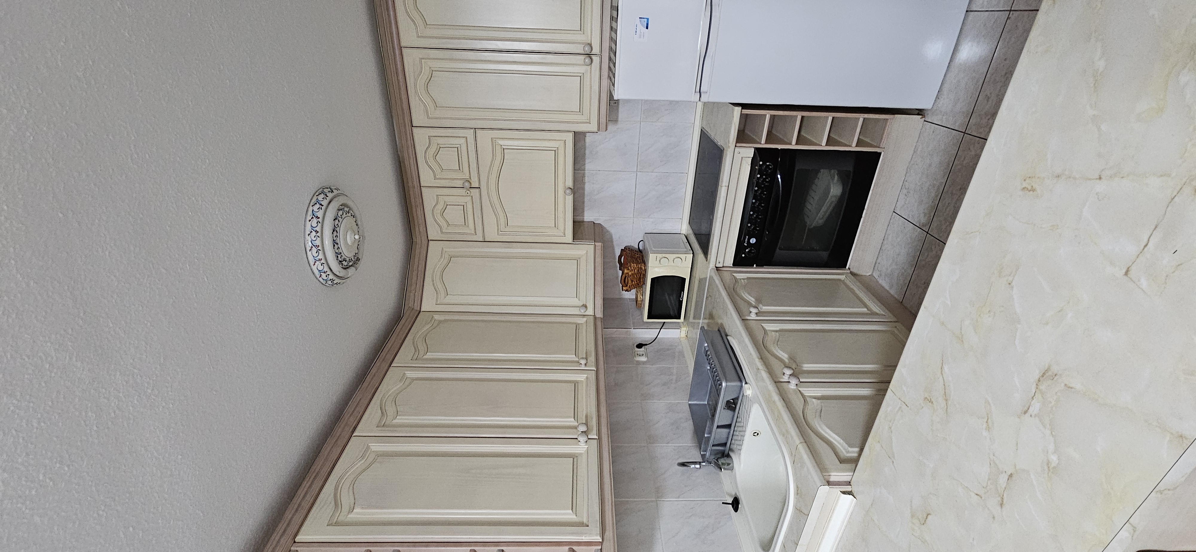 Fitted kitchen with oven, microwave and fridge