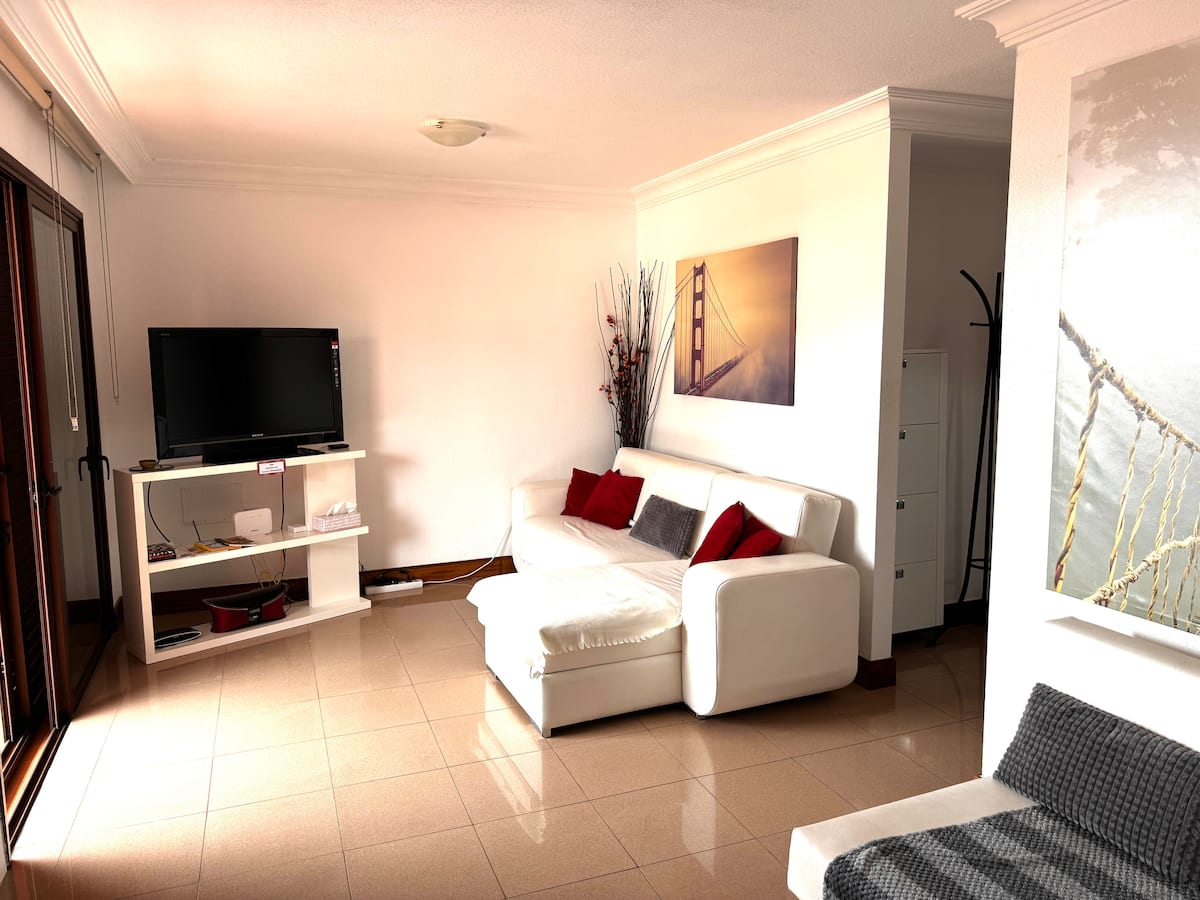 Living room with TV and white sofa