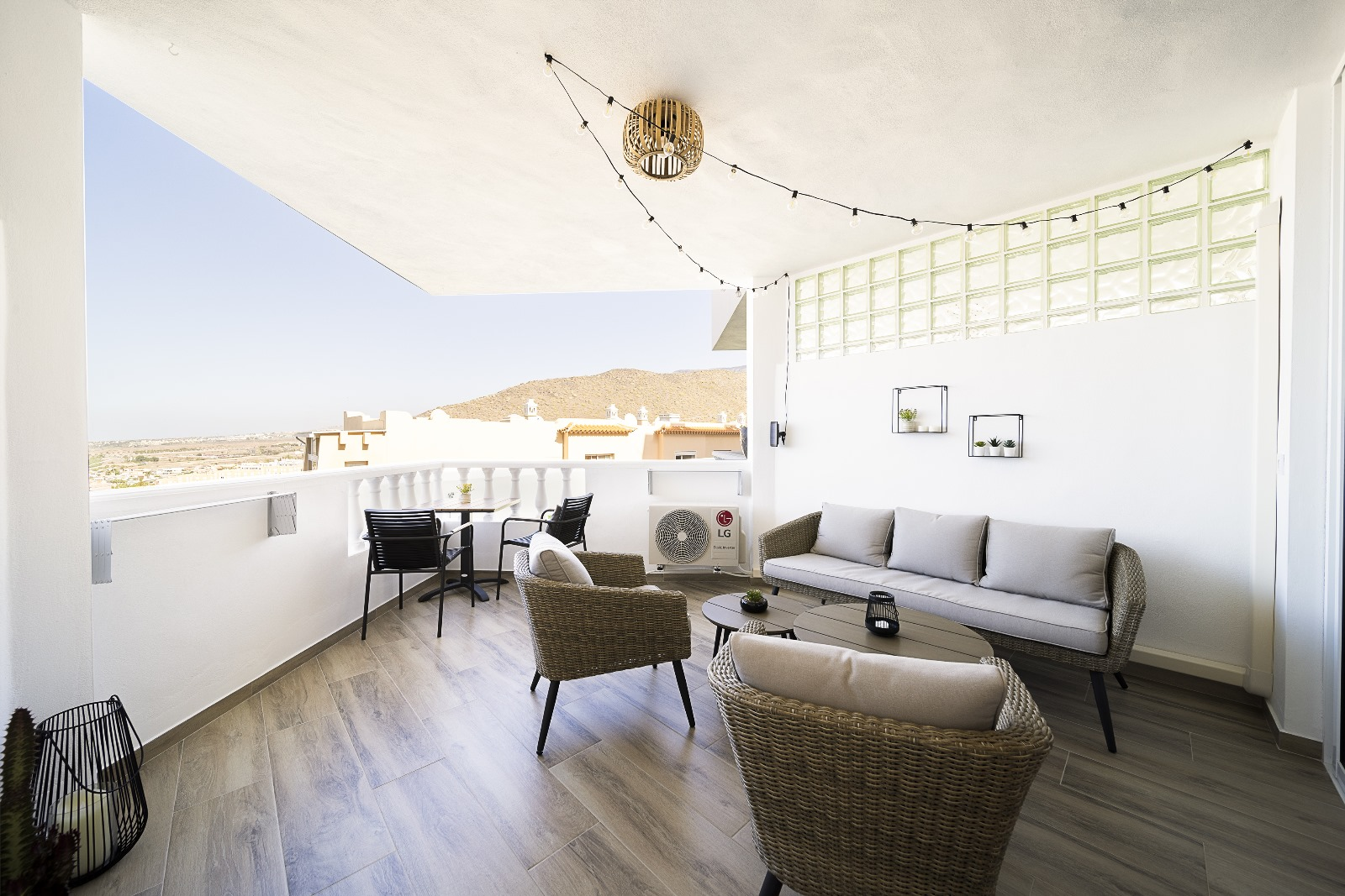 Terrace with rattan seating and string lights