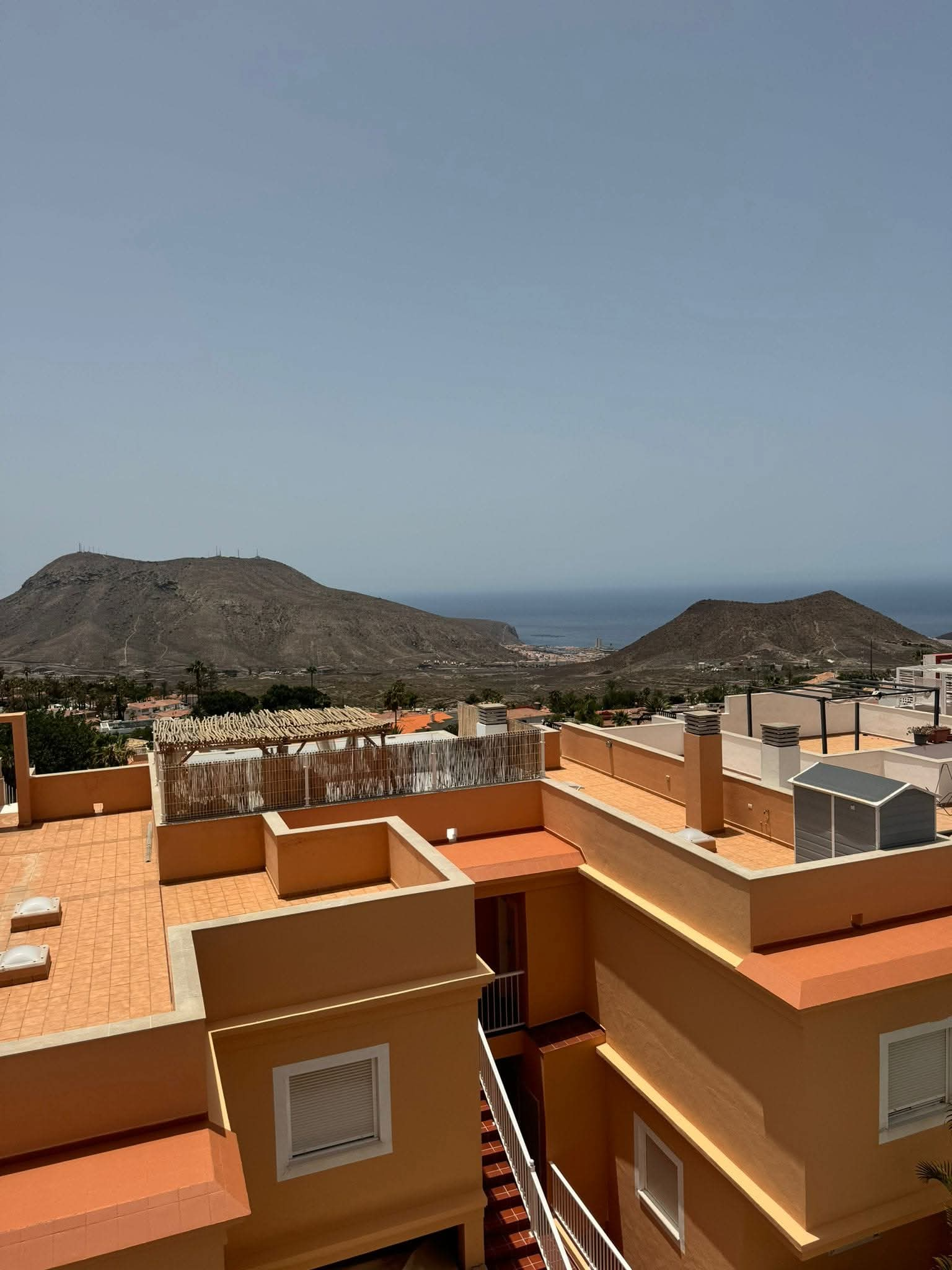 View over the rooftops to mountain and sea