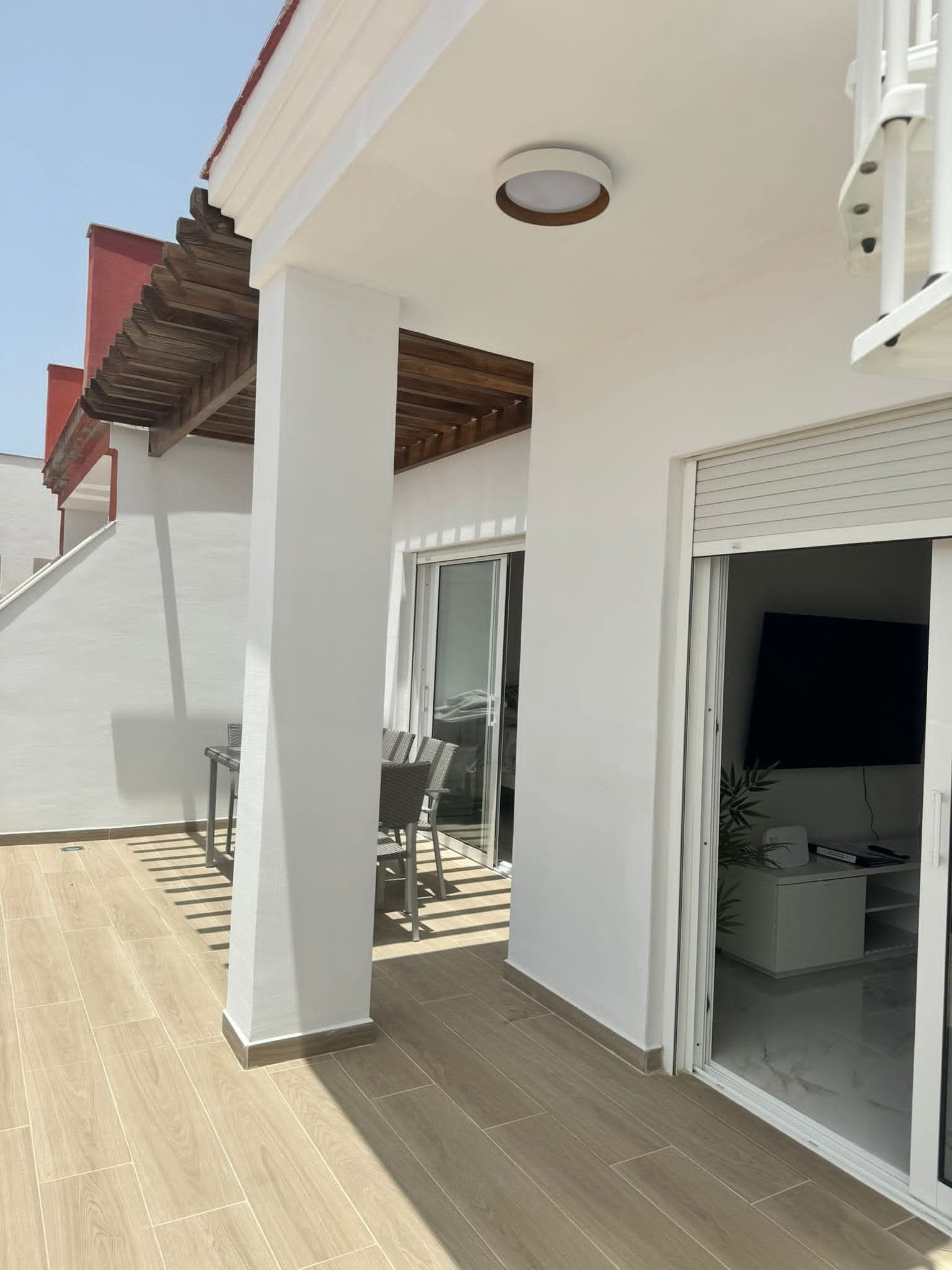 Covered terrace opening into the living room