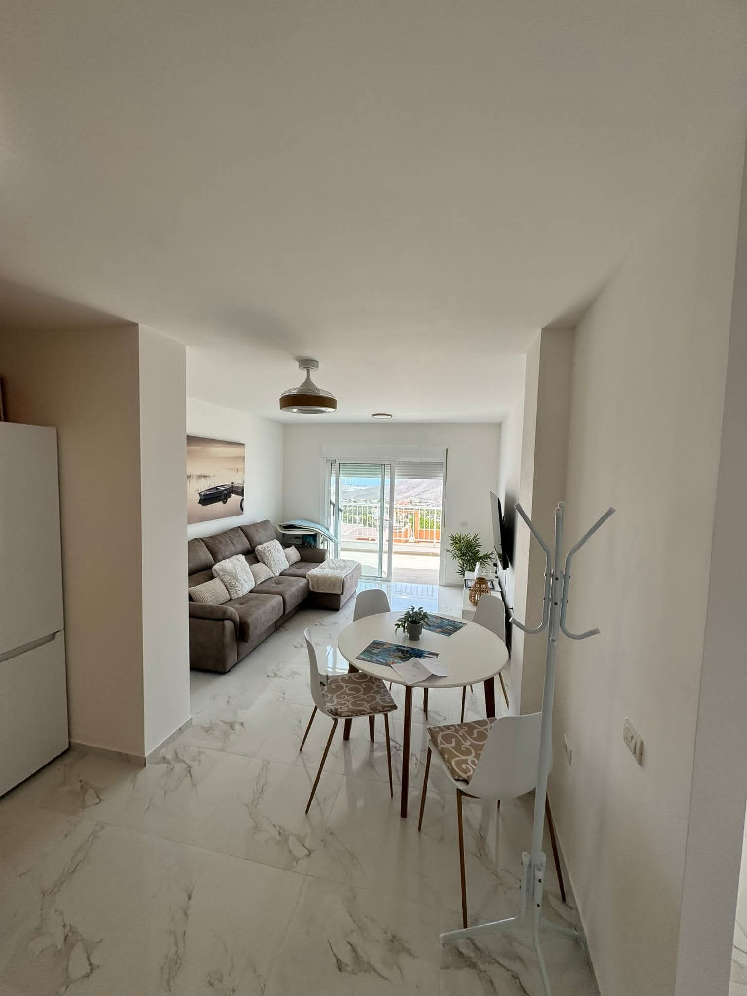 Living room with dining table, terrace behind